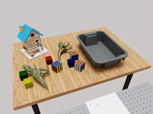 RoboLab 场景：桌面上有玩具屋、积木与灰色收纳箱，对应 CleanUpToys 任务。