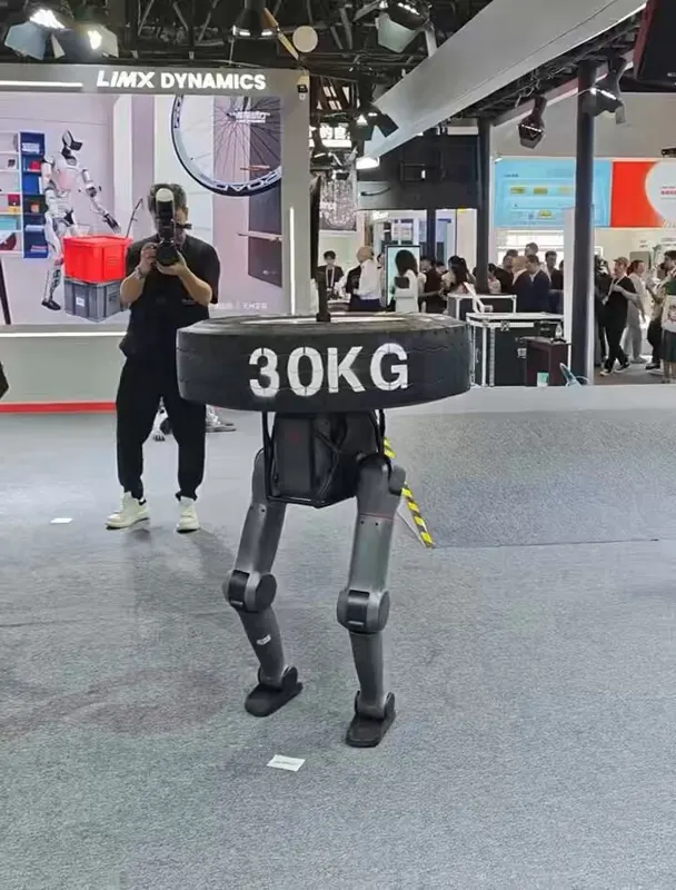 LimX TRON 2 walks carrying a 30kg tire — modular biped/quadruped/centaur
